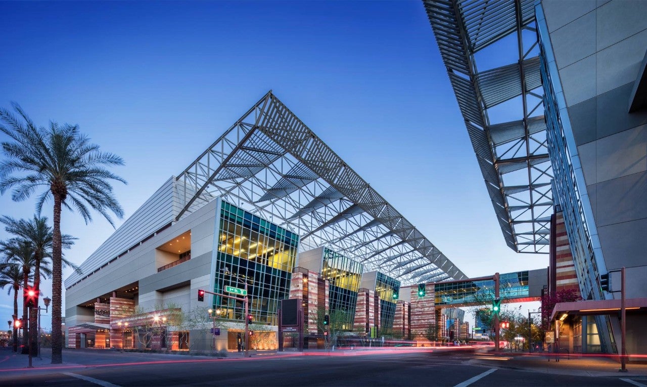 The Phoenix convention center building. It is a modern, angular building, with overhangs and a walkway over the street to another wing of the building.