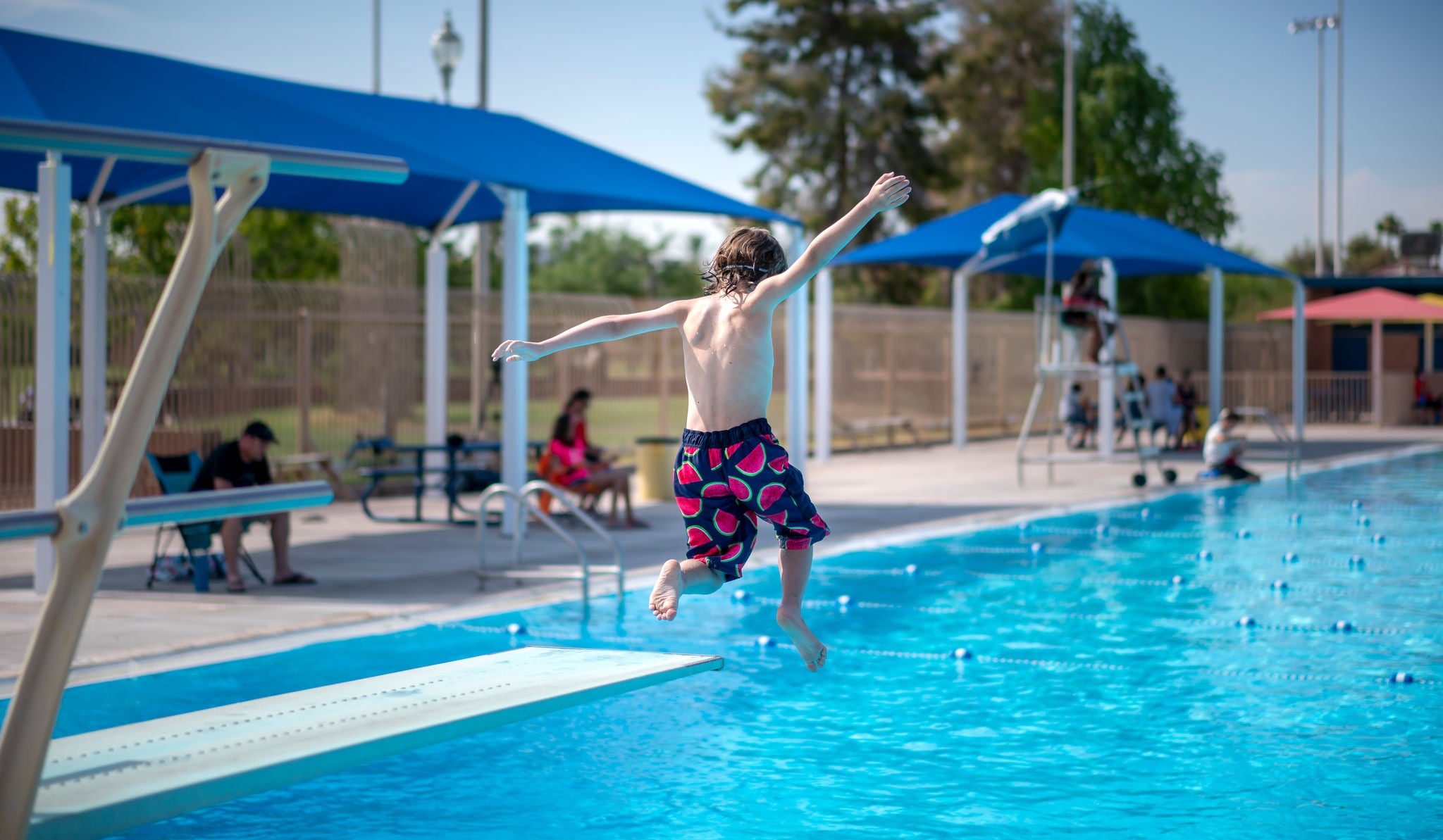 A child jumps into Encanto pool.