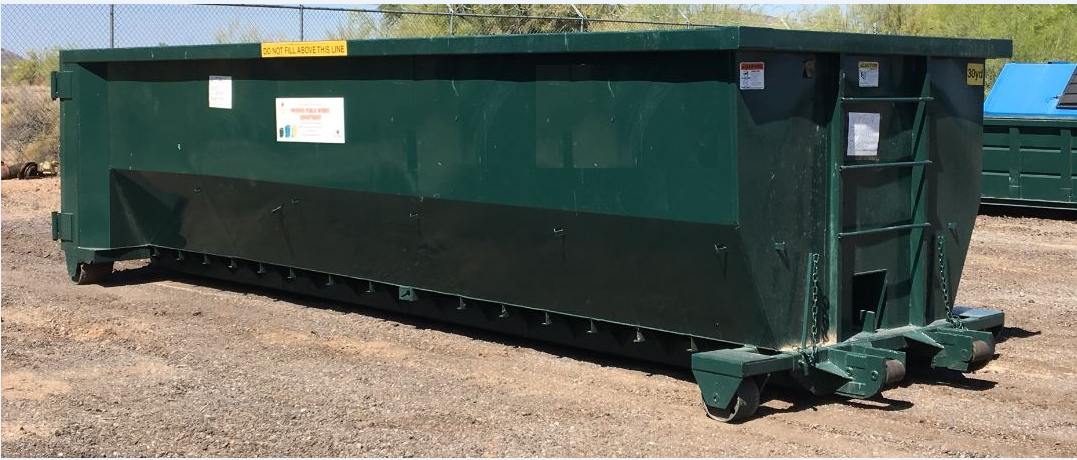 A green roll-off dumpster