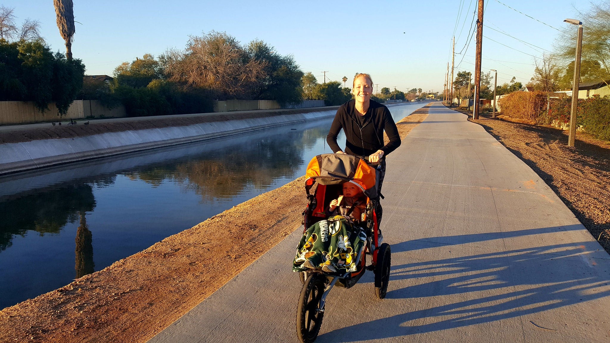 Woman pushing stroller on Grand Canalscape