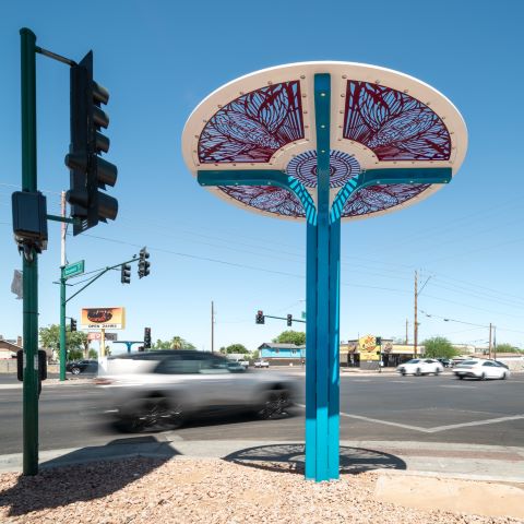 person standing under shade structure with concrete base