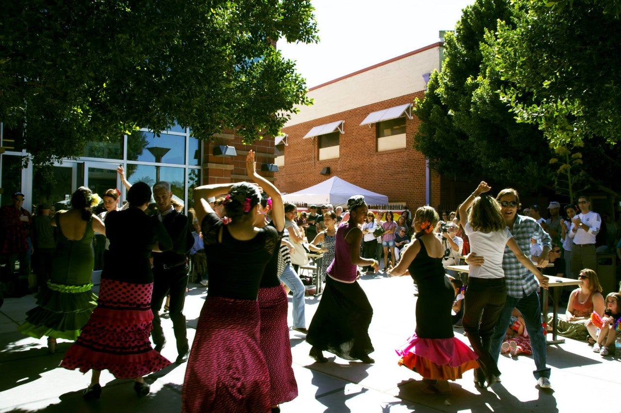 Performers dance outside.