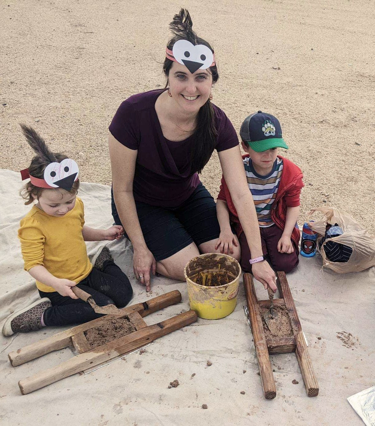 Mother and children learning to make adobe bricks.