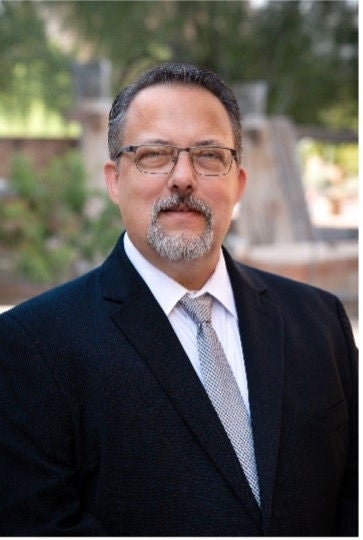 Assistant Public Defender Ted Crews. He is wearing a suit and looking at the camera.