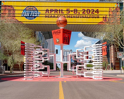 Outdoor NCAA Men's Final Four display featuring a basketball-themed installation and a banner promoting the event from April 5-8, 2024