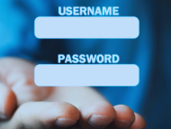 A man’s right hand, wearing a blue shirt, is reaching forward with his palm facing up, as if offering something. Above his hand, the word “Username” appears with a text box for entering a username. Below it, the word “Password” is shown with a space to type in a password. The image represents online login security.