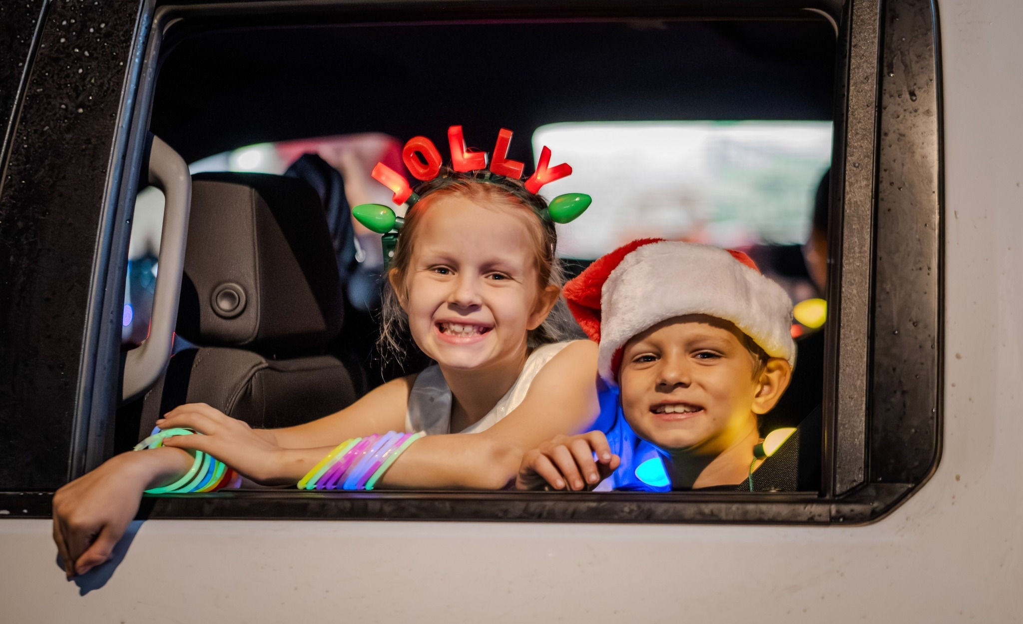 A photo of two smiling kids at the electric light parade