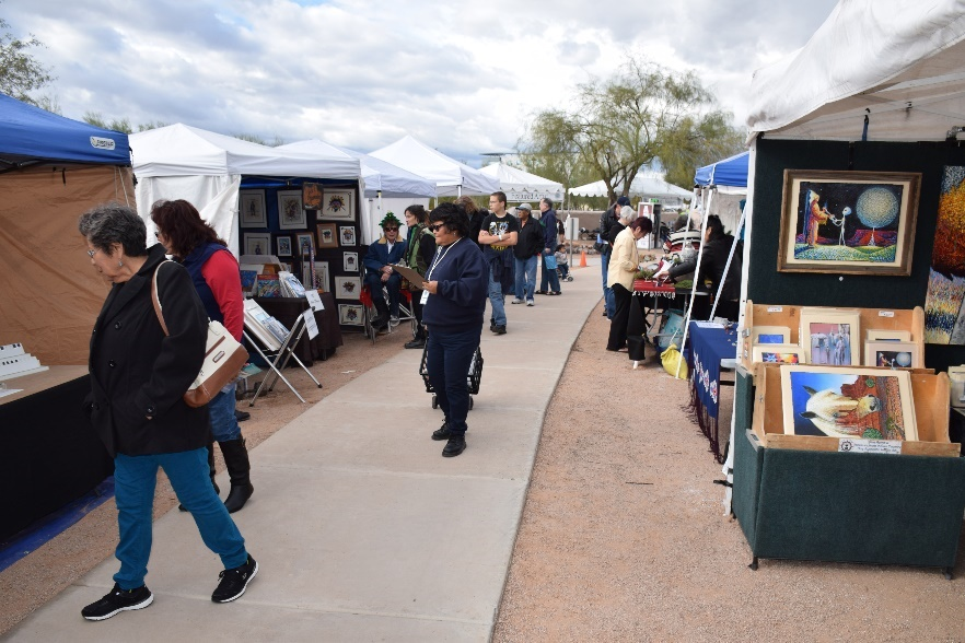 Visitors browsing artist booths at Indian Market