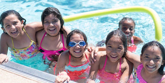 Six girls play in a City of Phoenix swimming pool.