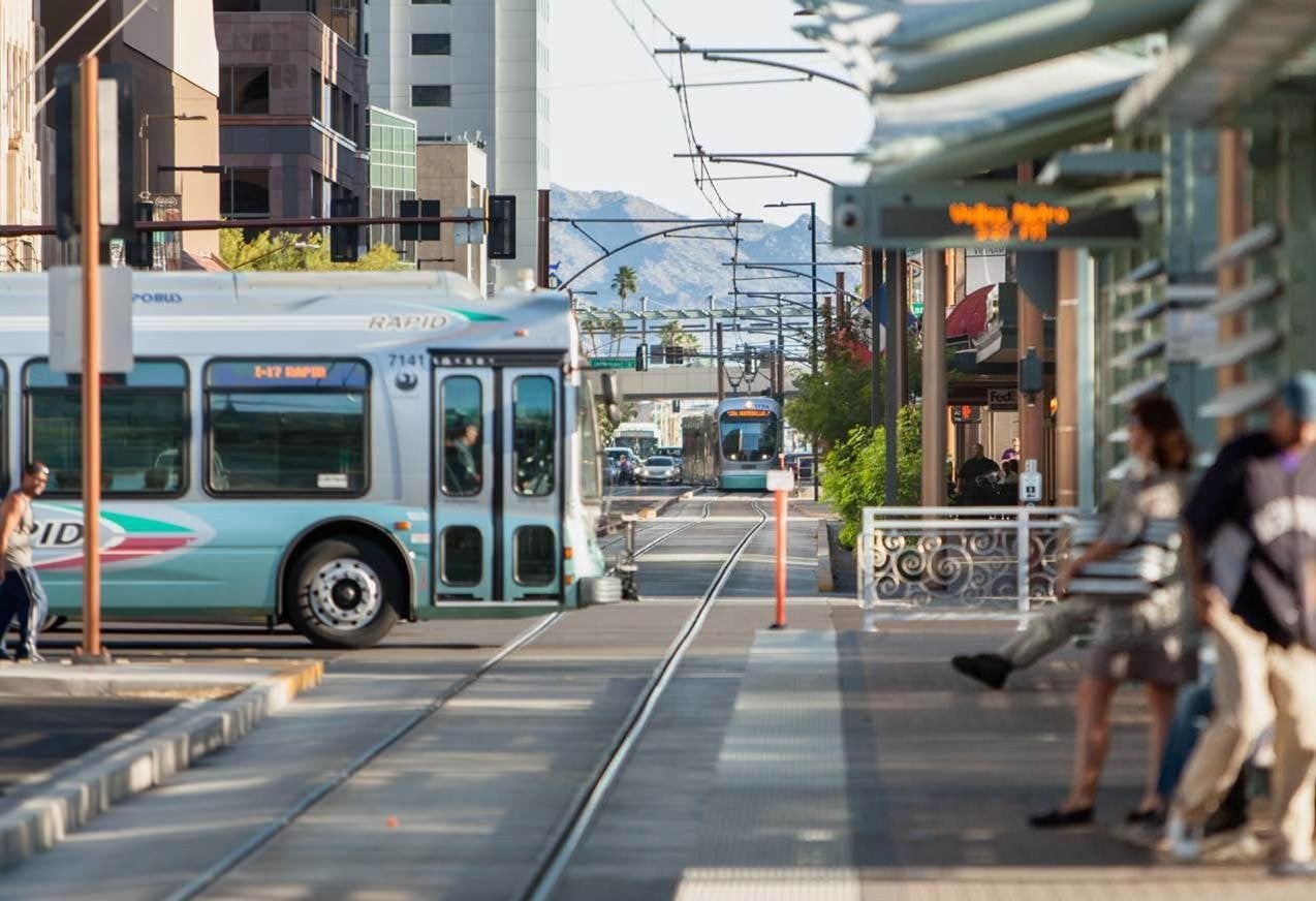 City bus driving over light rail tracks in downtown Phoenix