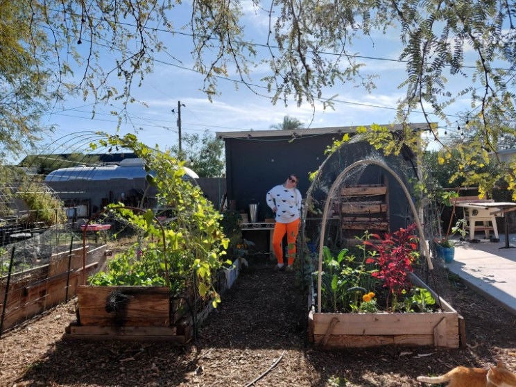 The CEO of Garden Hoes, Tabitha Helton, standing in her urban farm.