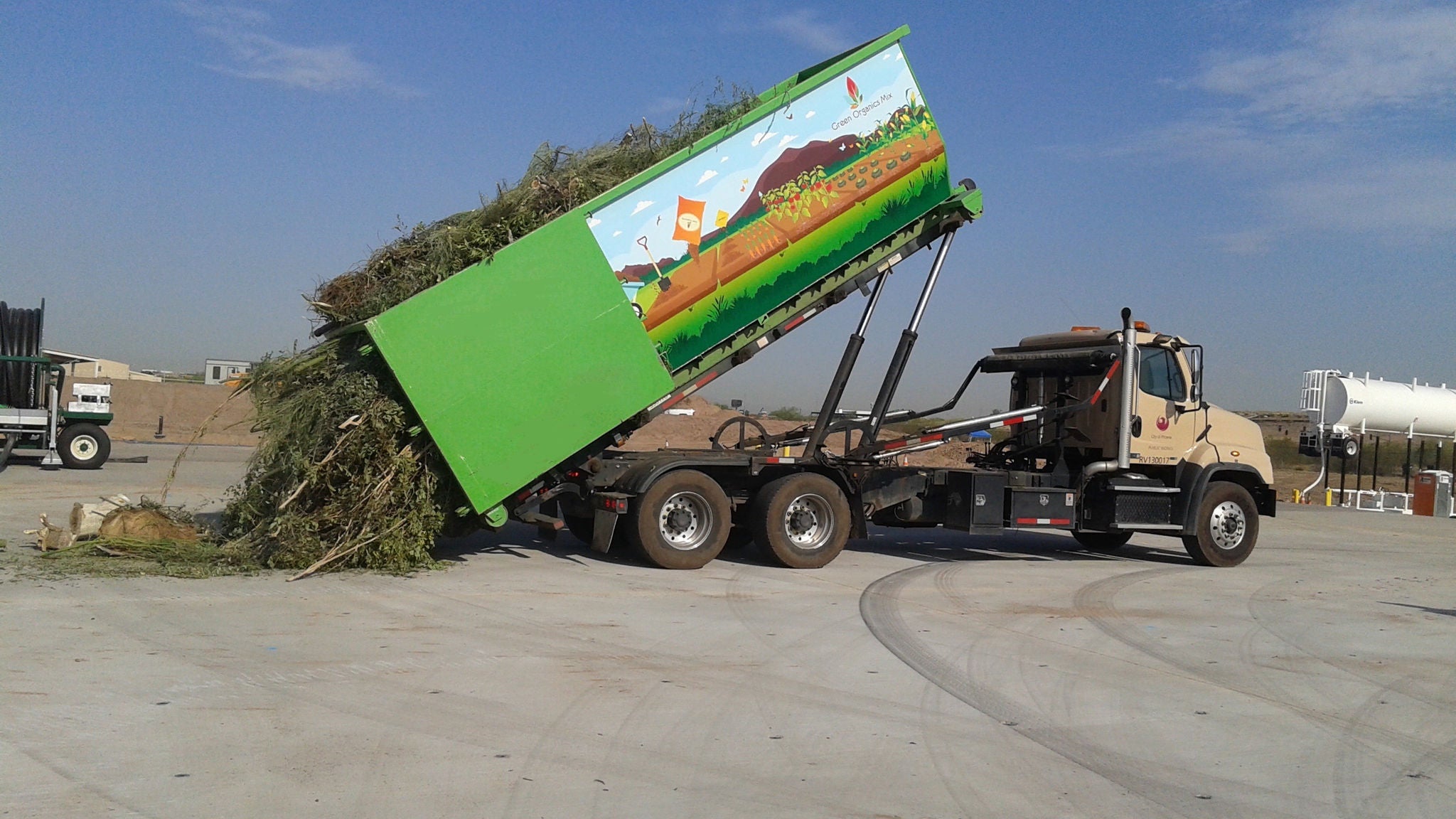 A truck drops off clean green waste at the transfer station.