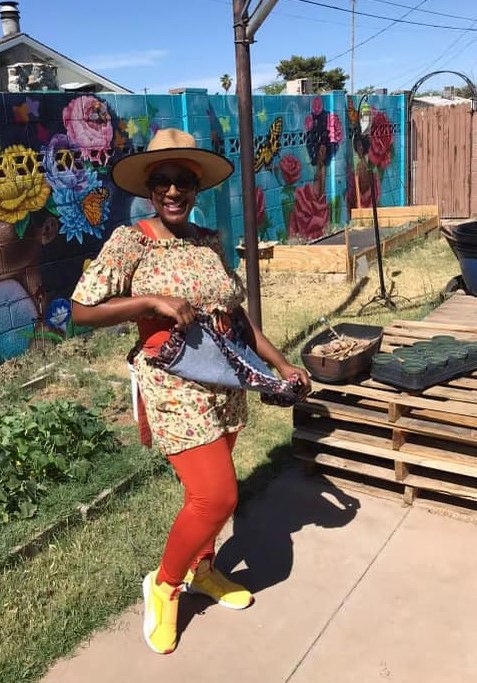 Patrice Clark, Founder of Emerald Roots Farm Collective stands in front of her urban farm