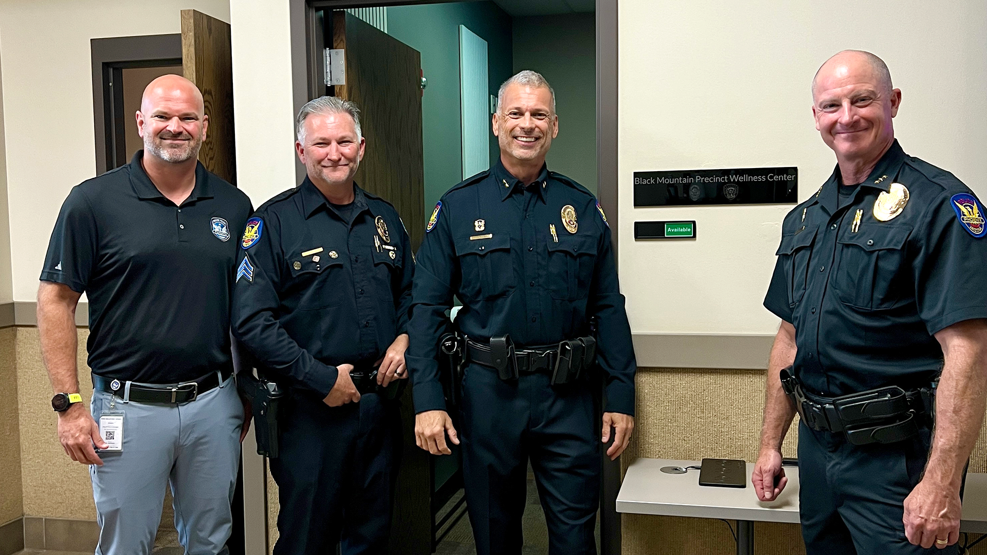 Black Mountain Precinct leaders along with Police Foundation leaders smile after holding a ribbon cutting and dedication ceremony for the new wellness center located at the precinct.
