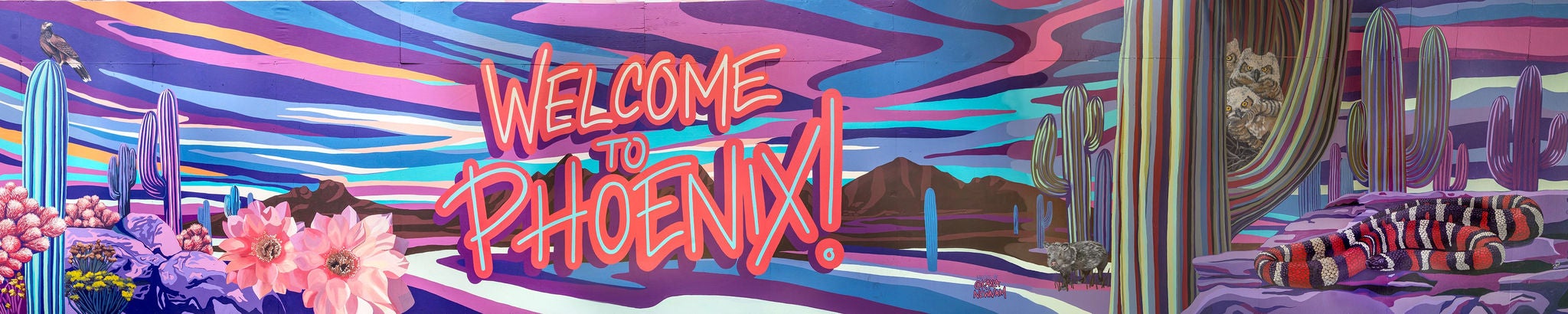 A wall with a mural painted on it with the words Welcome to Phoenix.