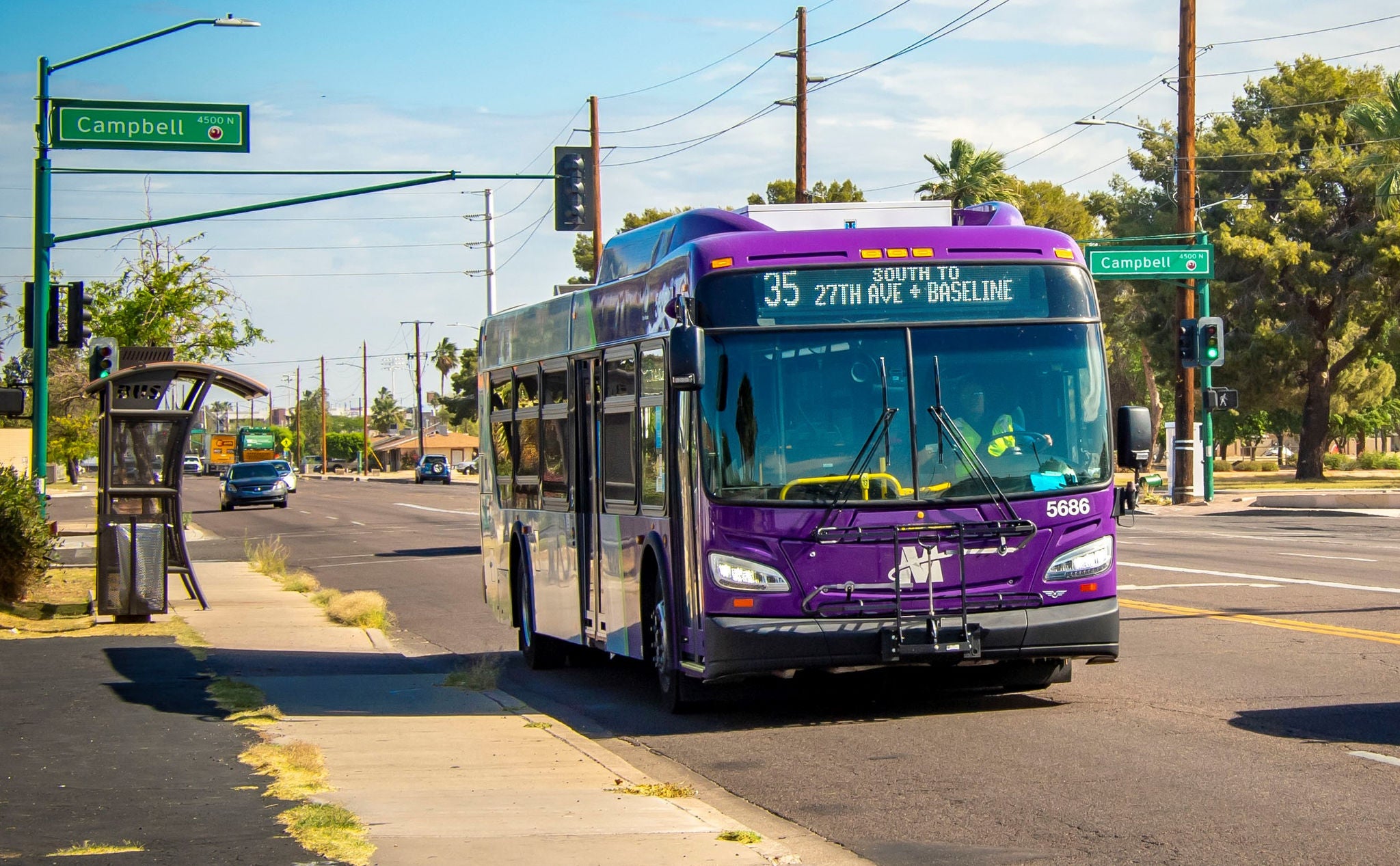 A bus operating on 35th Ave route stopping in front of a bus stop. 