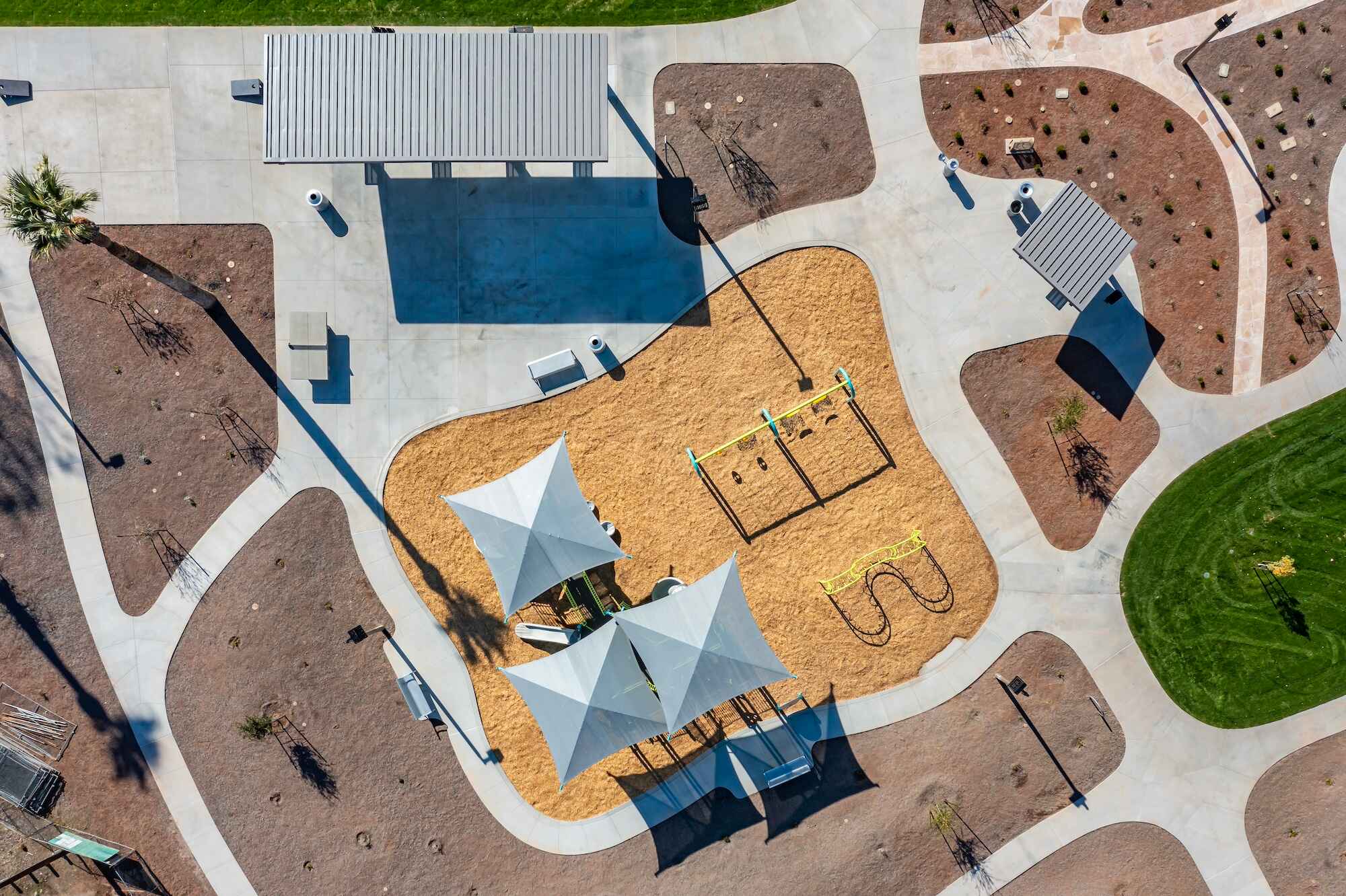 Overhead photograph of a Phoenix city park with ramadas, swingsets, and mulch.