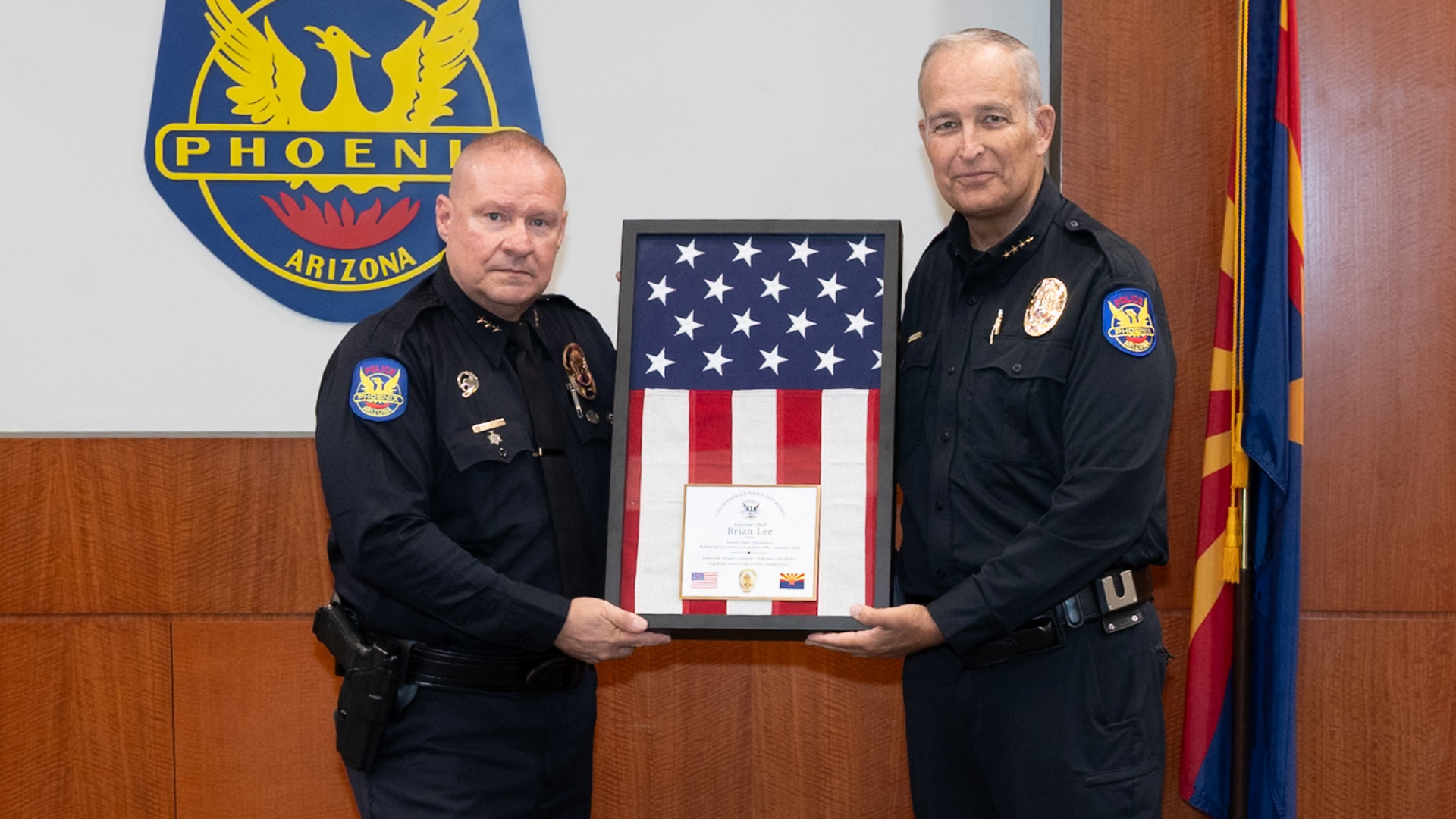 Assistant Chief Brian Lee accepting a retirement gift from Police Chief Matt Giordano at the conclusion of his 36 year career as a police officer.