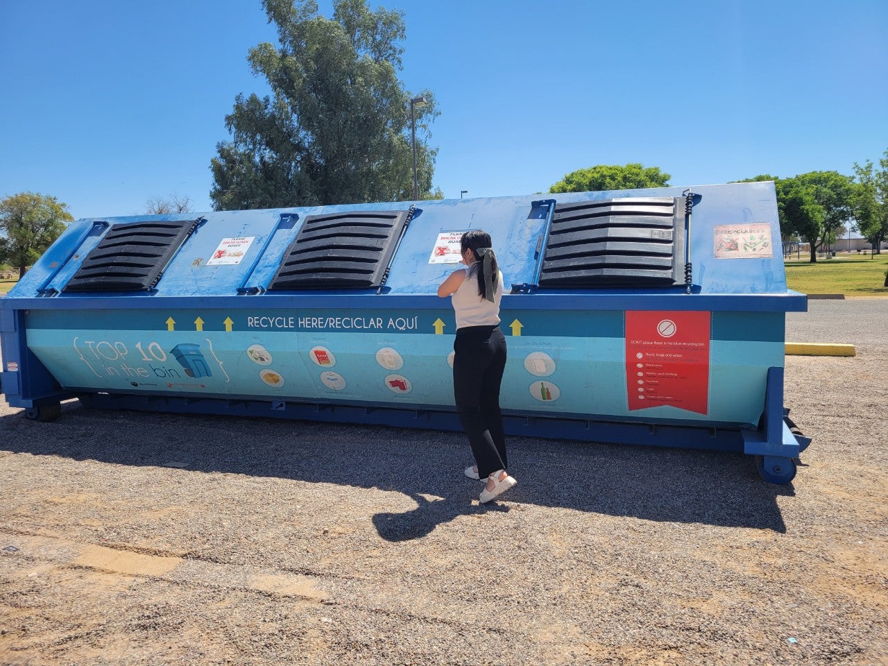 A resident brings recyclables to an Eco-station in a Phoenix park.
