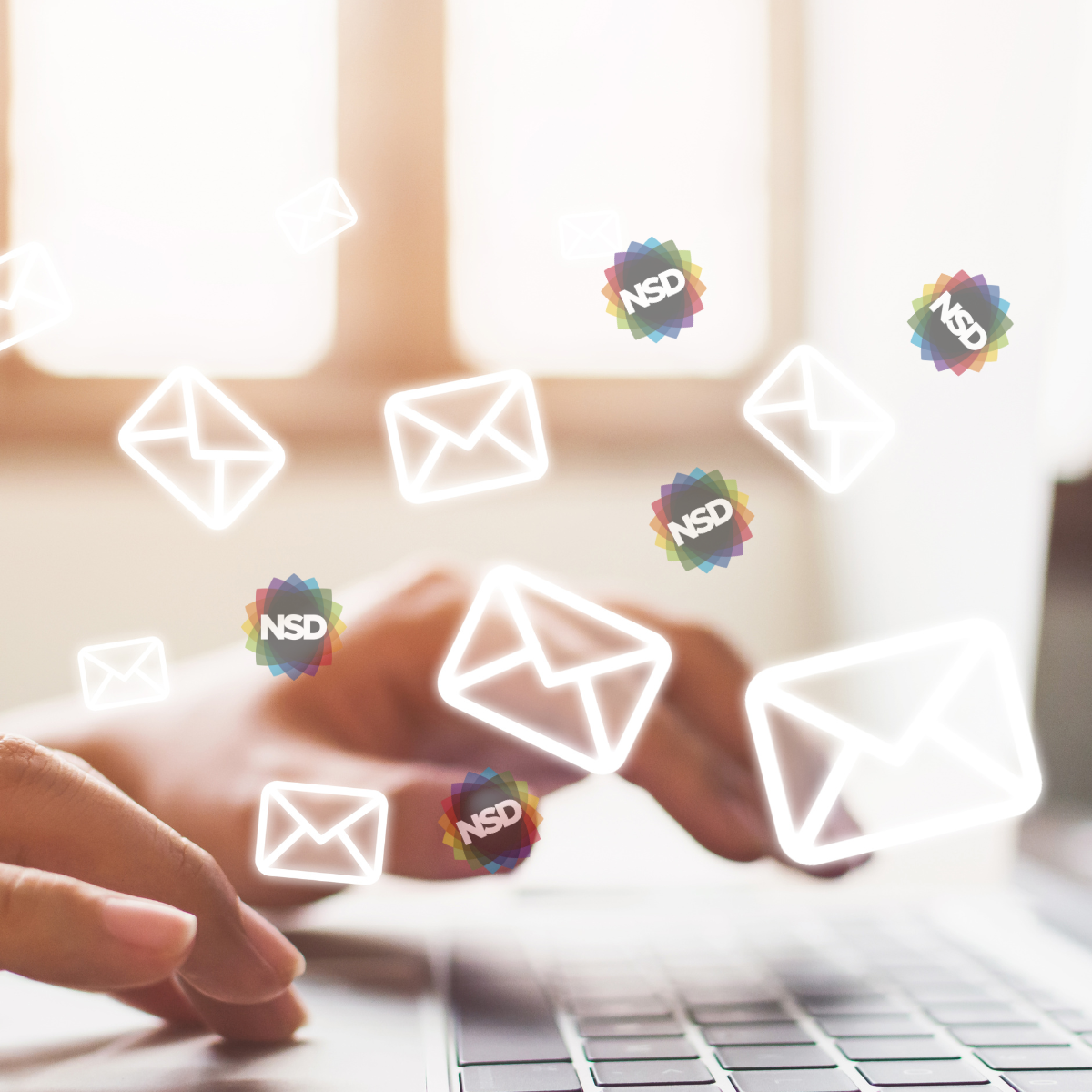  A close up of hands typing on a laptop keyboard with floating envelope icons and the NSD logos superimposed, as if coming coming out of the device.