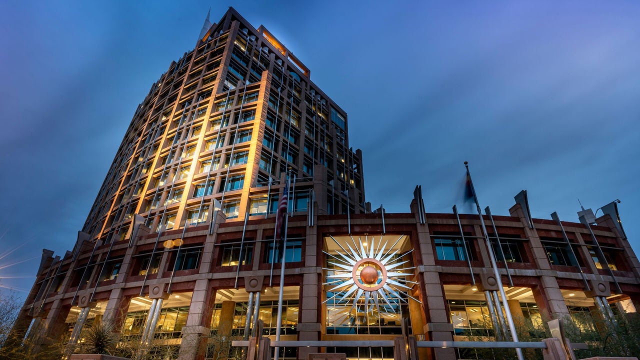 Night time picture of Phoenix City Hall with sunburst illuminated with lights