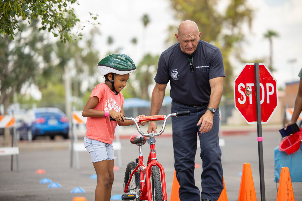 Fireman helps a young bicycle rider